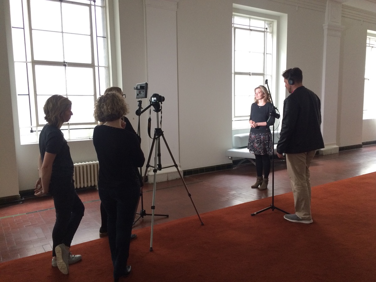 A team filming an interview during a training session